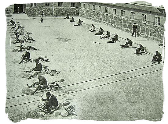 Poster at the Robben Island museum of prisoners chipping stones in the courtyard of Robben Island prison